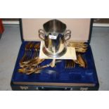 Silver plated two handled bottle cooler and a gold plated canteen of cutlery in fitted case