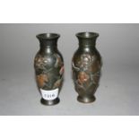 Pair of small Japanese bronze baluster form vases with relief decoration