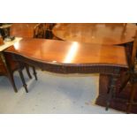 Mahogany serpentine shaped side table in Adam style, the gadroon moulded top above a carved and