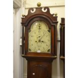 George III mahogany longcase clock with an arched hood above arched panelled door on plinth base,