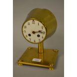 Brass pedestal cylinder clock, the enamel dial with Arabic numerals, with a two train movement,