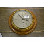 20th Century circular oak cased wall clock having circular silvered dial with Arabic numerals,