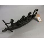 African brown patinated bronze group of four figures in a boat