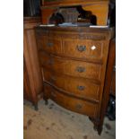 Reproduction walnut serpentine fronted chest of two short over three long graduated drawers with