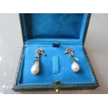 Pair of diamond and pearl bow design drop earrings