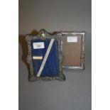 Two silver rectangular photograph frames