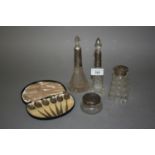 Four various silver mounted glass dressing table bottles, together with a cased set of six silver