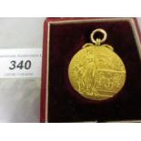 15ct Gold 1909 London Professional Football charity fund medal, in a fitted case (the case later