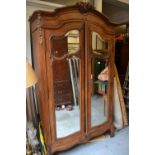 Late 19th / early 20th Century French armoire having moulded and carved cornice above two mirrored