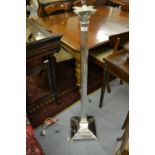 Silver plated Corinthian column standard lamp having stepped platform base with hairy paw feet,