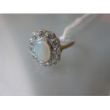 Platinum oval opal and diamond cluster ring