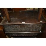 17th Century carved oak bible box, the hinged lid above decorated plank sides on an associated stand