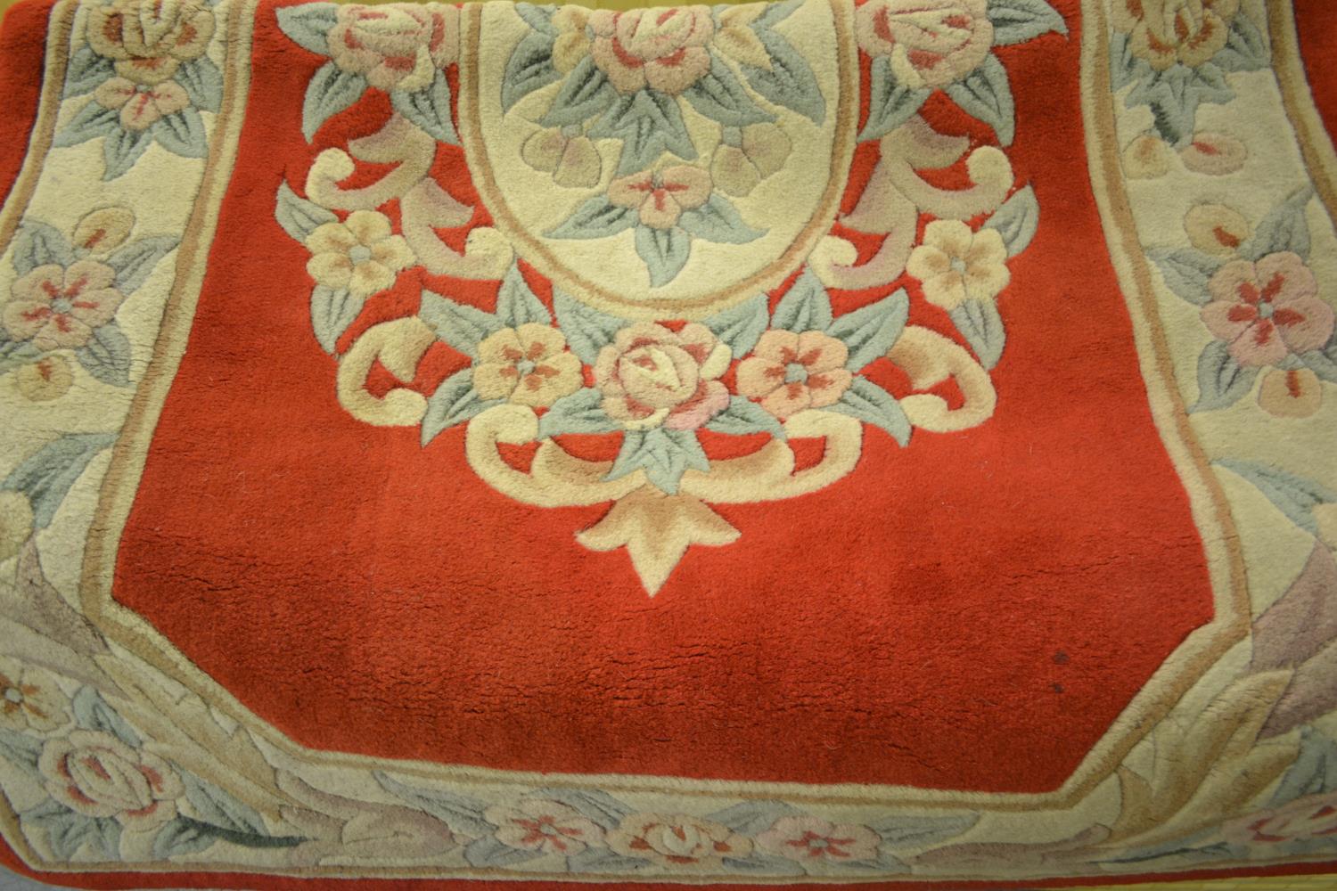 Chinese deep pile all-over floral decorated rug on a beige and red ground, together with a similar