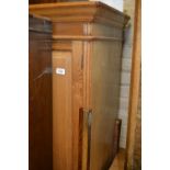 Late 19th / early 20th Century ash wardrobe, the moulded cornice above a single long panelled