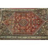 Small 20th Century Qashqai rug with a medallion and floral design on a rose ground with borders,
