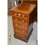 Pair of mahogany slim chests of five drawers with circular brass ring handles, raised on plinth