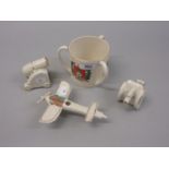 Group of four various crested porcelain figures in the forms of an aeroplane, artillery gun,