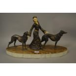 Art Deco style figure of a lady with two dogs on marble base, 30.5ins high, 23ins long