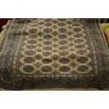 Pakistan Bokhara design rug on beige ground, 239cms x 155cms