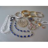 Two gilt metal lockets, four various bangles, 9ct dress ring, coral set ring and a small quantity of