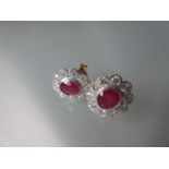 Pair of 18ct yellow gold oval ruby and diamond stud earrings