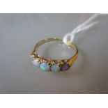 Yellow gold ring set five circular graduated opals