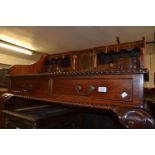 Reproduction mahogany desk with drawers, alcoves and a cupboard door above two drawers raised on