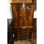 Reproduction figured mahogany cocktail cabinet, with a moulded cornice above a pair of figured panel