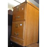 Small light oak two drawer filing cabinet with brass mounts together with a mahogany D-shaped side