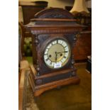 Late 19th Century German walnut mantel clock, the ceramic dial with Roman numerals with a two