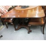 George IV style mahogany three pillar dining table on turned supports with platform bases and scroll