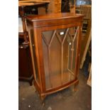 Reproduction yew wood bow front display cabinet with a single bar glazed door enclosing glass