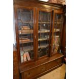 Mahogany bookcase, the moulded cornice above three satinwood crossbanded and astragal glazed