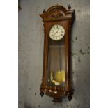 Early 20th Century Continental walnut Vienna wall clock, the enamel dial with Roman numerals, the