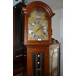 Mahogany longcase clock, the broken arch hood above a bevelled glass panelled door and conforming