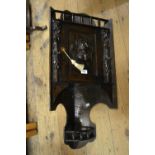 19th Century oak hanging corner cabinet with a single door applied with a mask head, together with a