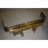 19th Century pierced brass fender on paw supports together with various fire tools etc