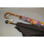 Black silk parasol with hardstone handle together with another floral decorated parasol