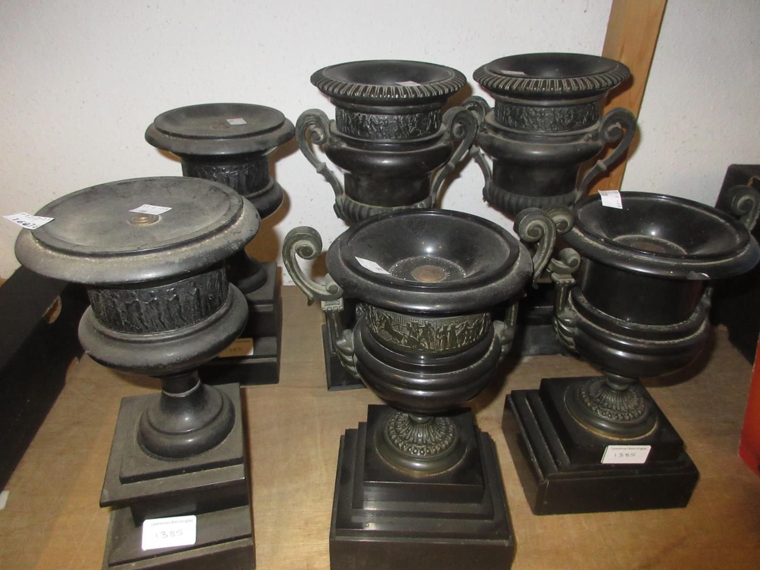 Three pairs of 19th Century black slate clock garniture side pieces