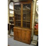 George IV mahogany bookcase, the moulded cornice above a pair of arched bar glazed panel doors