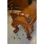 Victorian style window seat, the moulded panel top with two turned handles, raised on carved