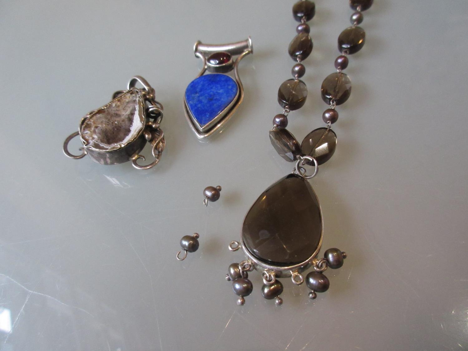Two large pendants and a large silver necklace
