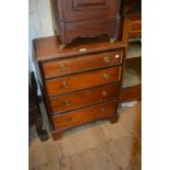 Mahogany dwarf chest of four drawers with brass ring handles on bracket feet (for restoration)
