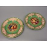 Pair of Royal Worcester plates, hand painted with various fruits by R. Seabright in circular central
