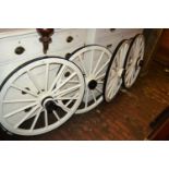 Set of four white painted wooden and iron cart wheels