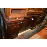 19th Century inverted breakfront sideboard having mirrored shelved back above four shaped fielded