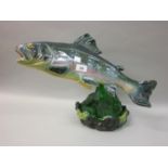 Large French pottery figure of a salmon on a pottery and green glass base, indistinctly signed and
