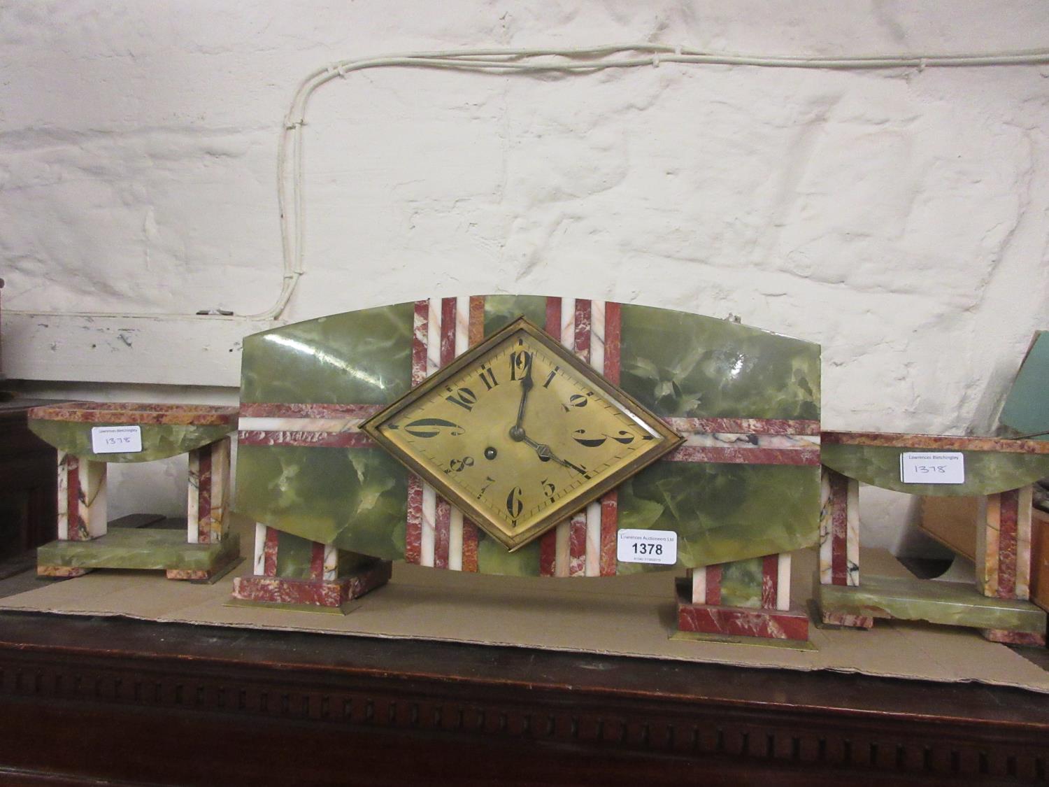 Art Deco green onyx and red and cream marble mounted three piece clock garniture, the diamond shaped
