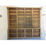 Large stripped and polished pine dresser / bookcase with moulded cornice above an arrangement of