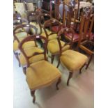 Set of six Victorian walnut balloon back dining chairs with carved rail backs, overstuffed seats and